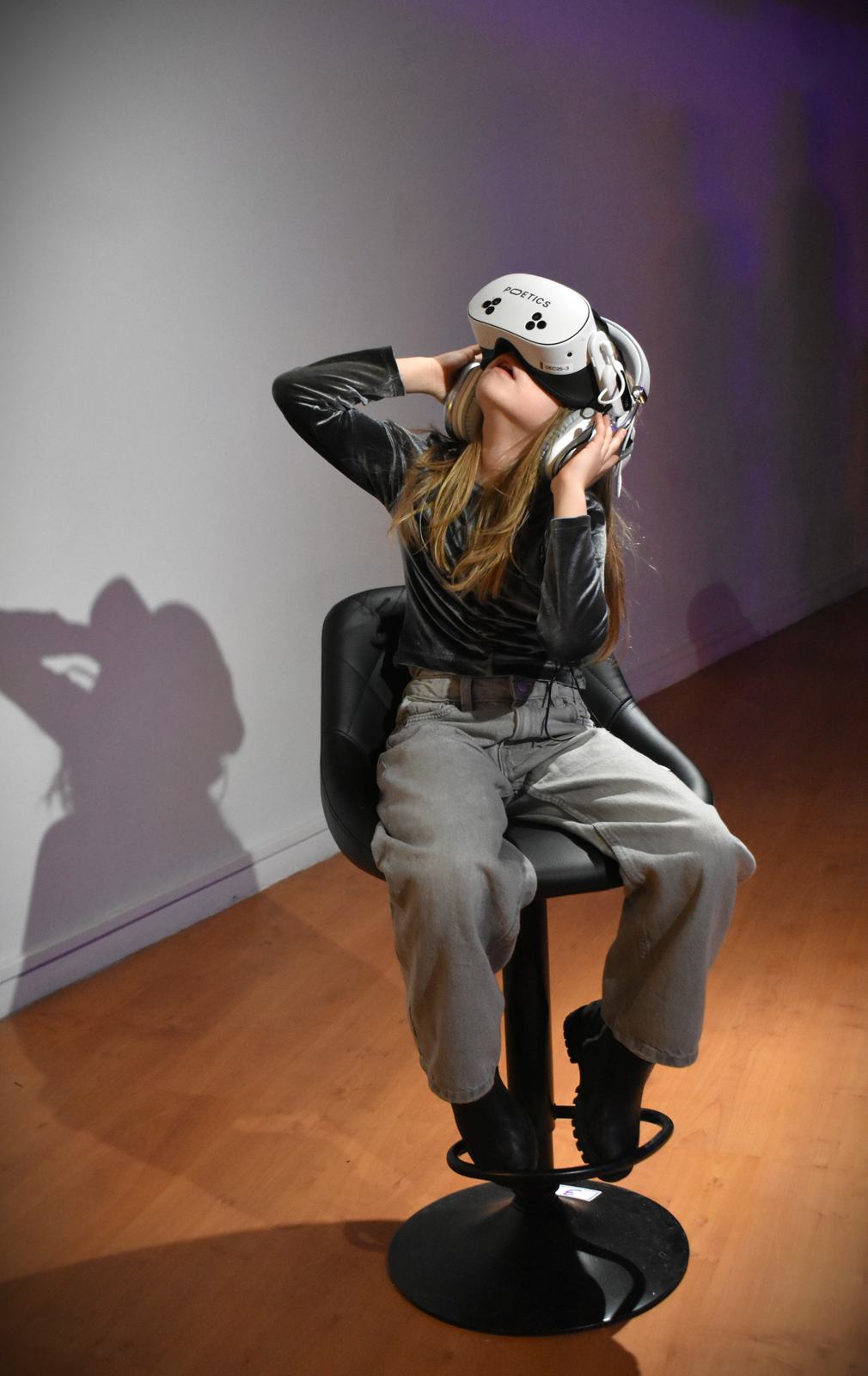 Young visitor seated with a Poetics VR headset