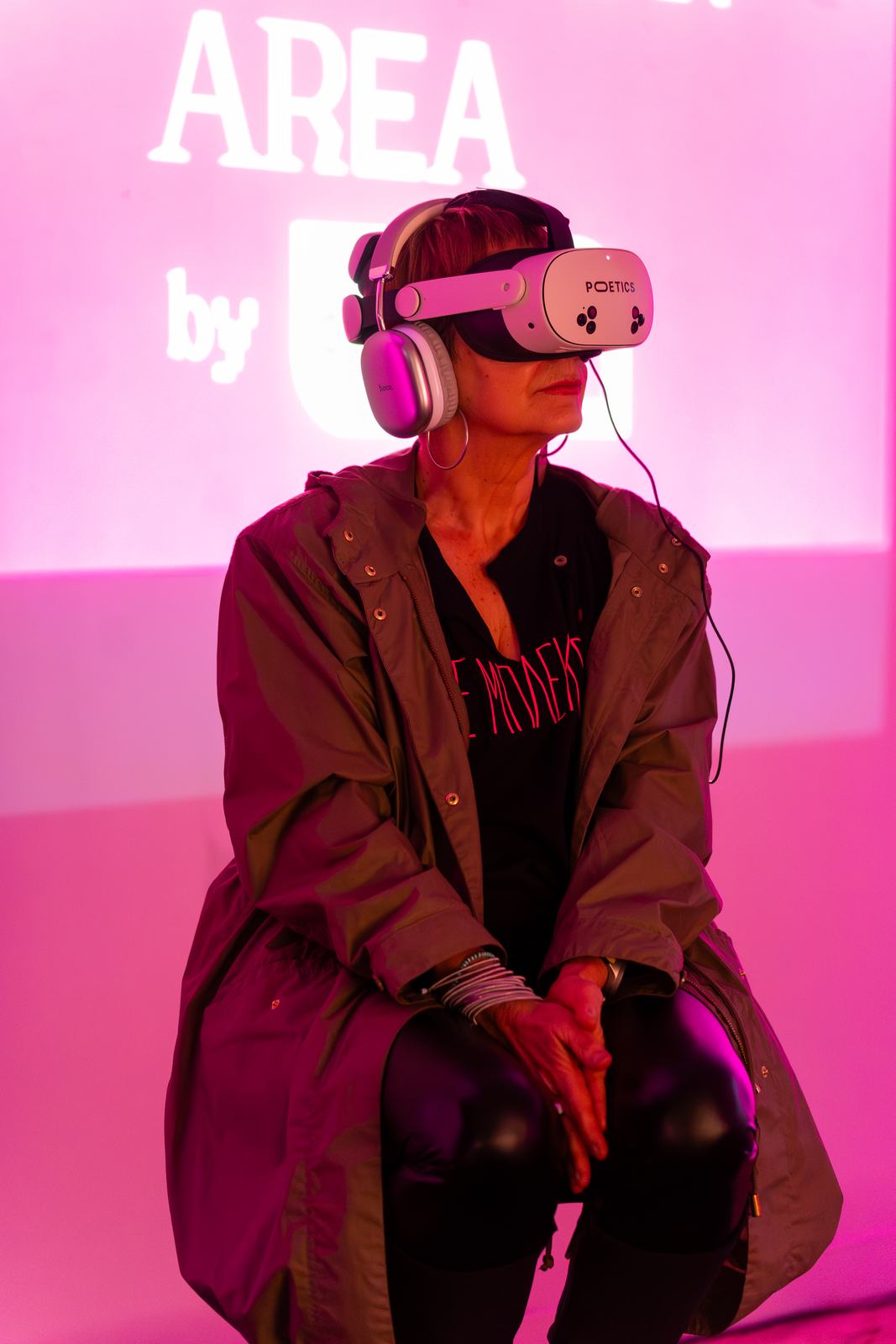 Visitor wearing a Poetics headset in pink light