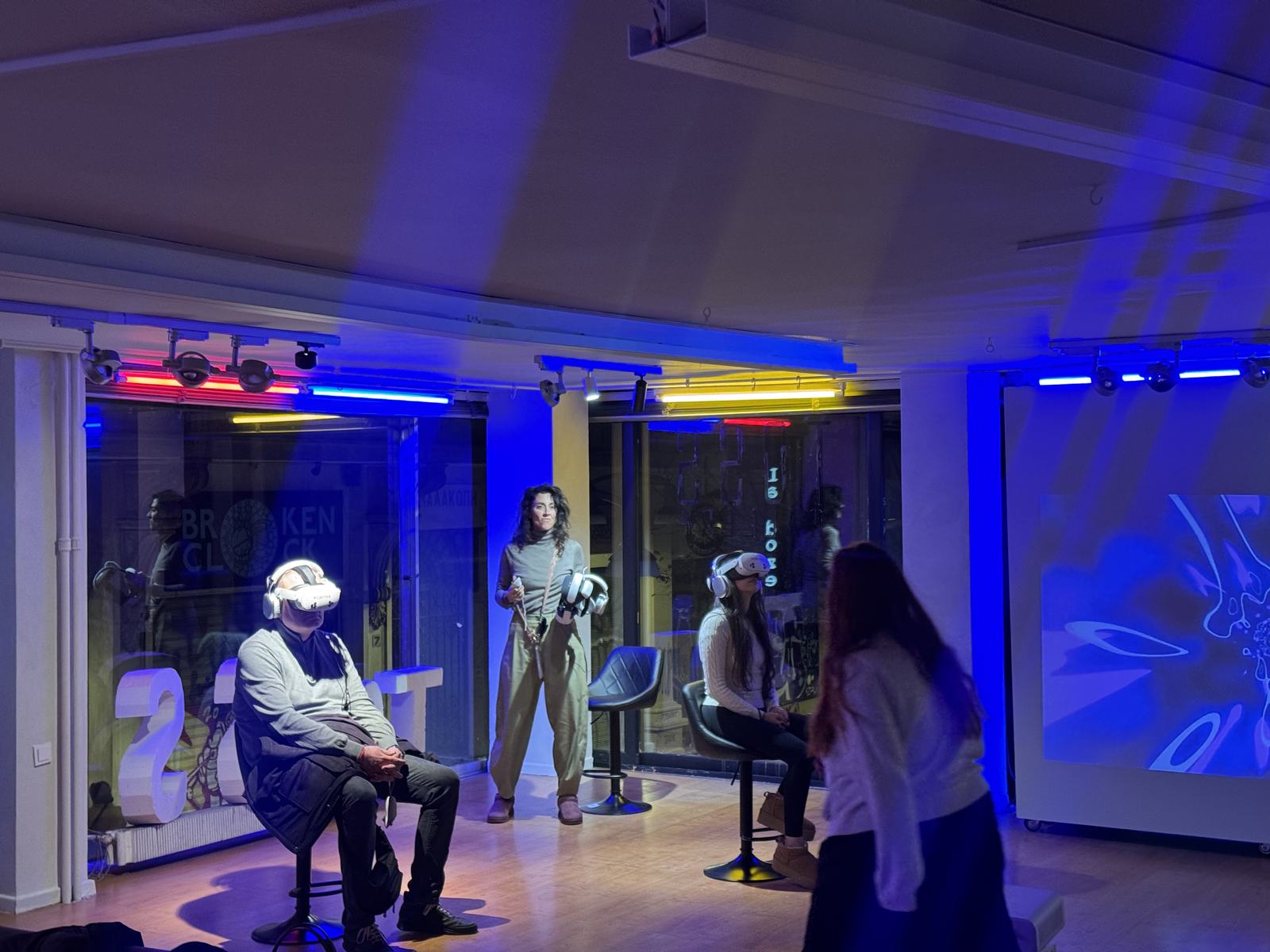 Visitor wearing a VR headset with audience in the background