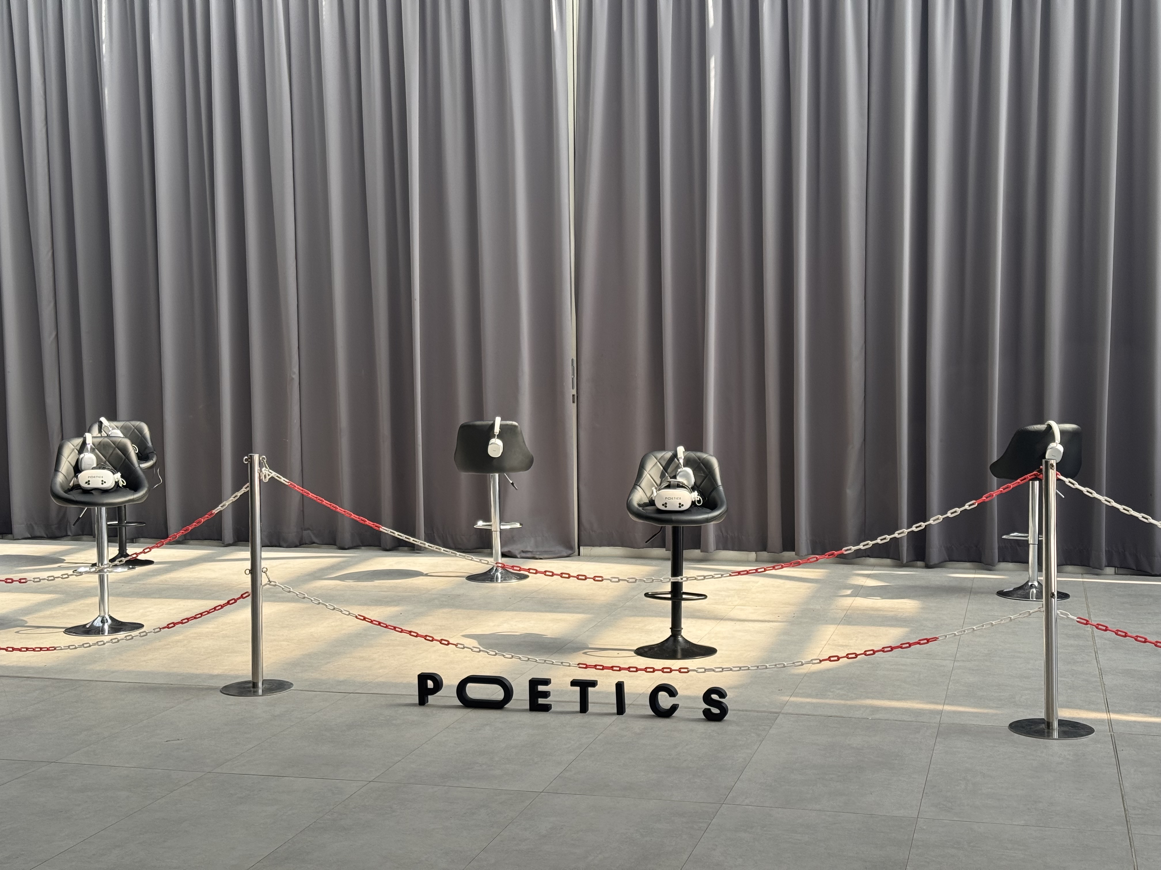 Poetics LBVR station setup with headsets and branded floor letters