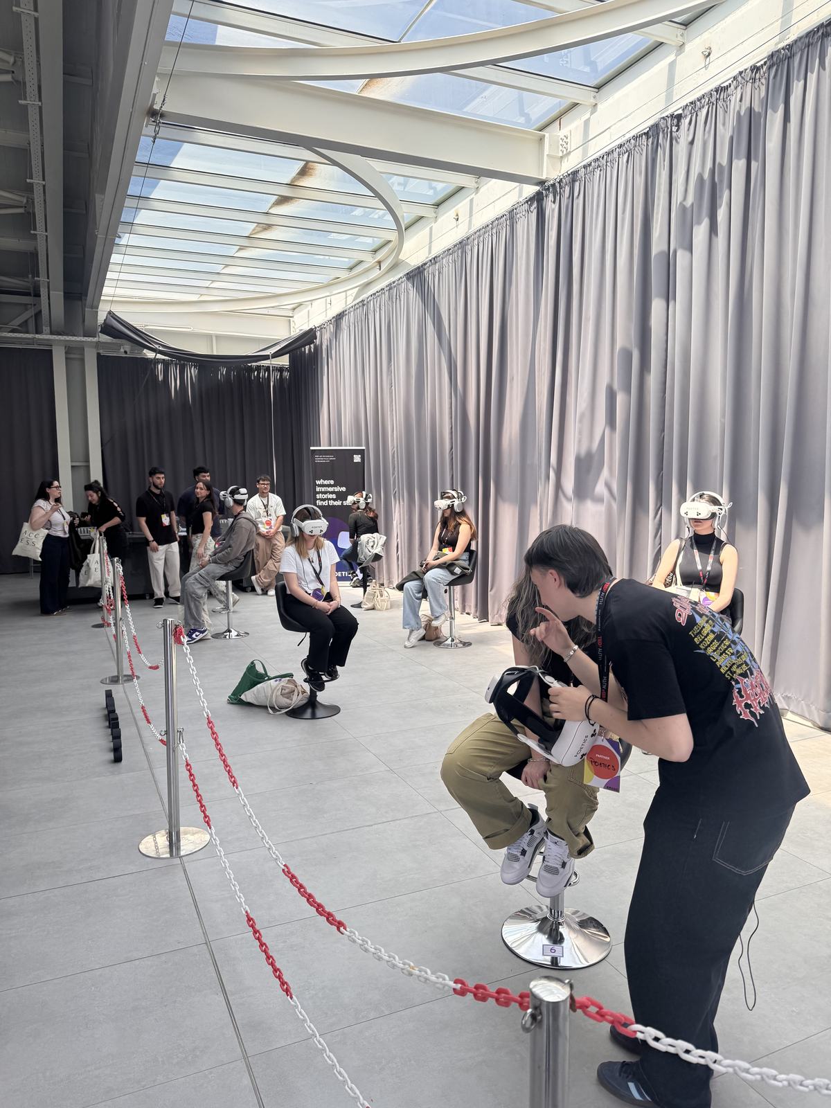 Audience queue and multiple Poetics VR stations at a bright event venue