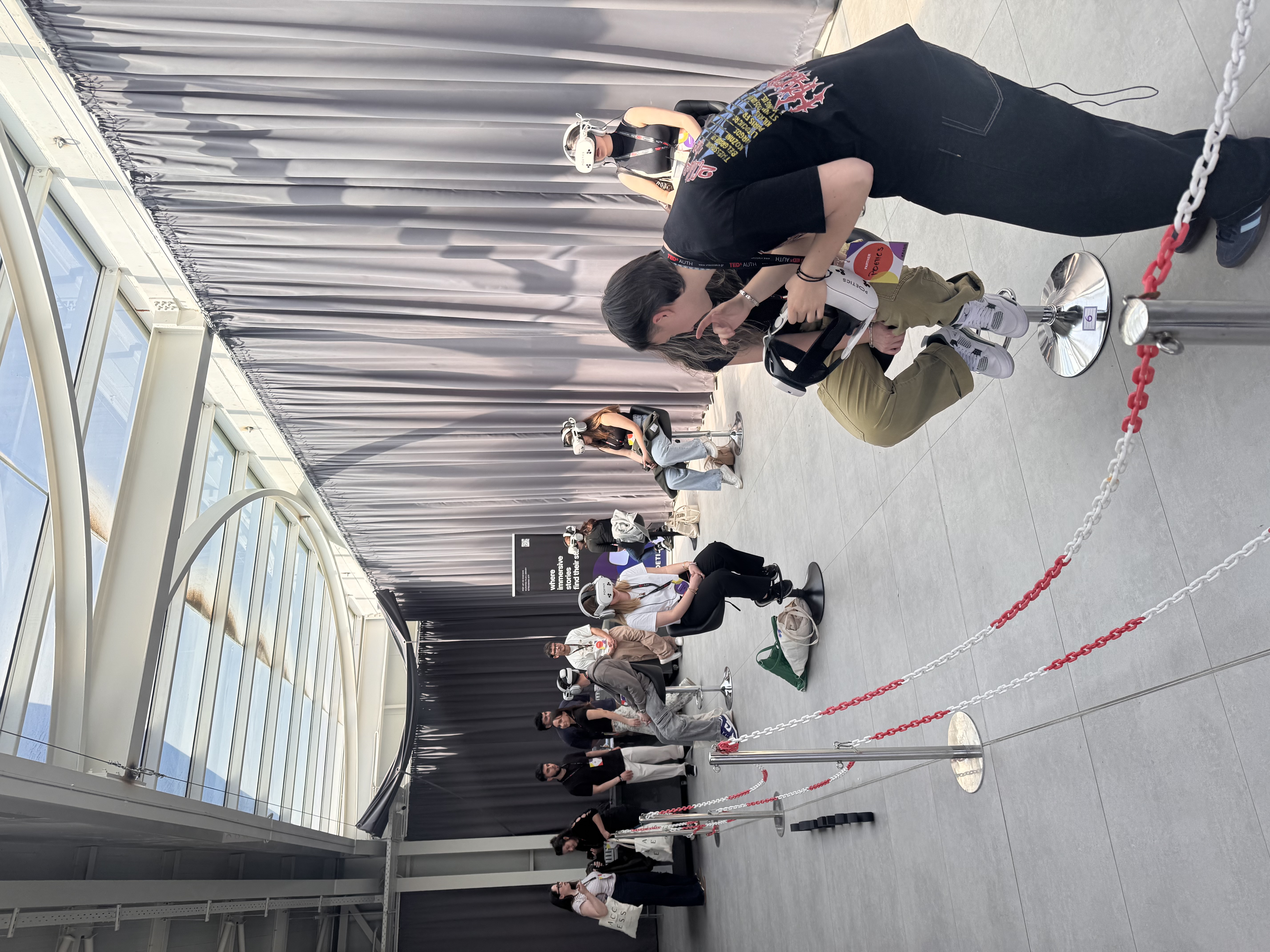 Audience queue and multiple Poetics VR stations at a bright event venue