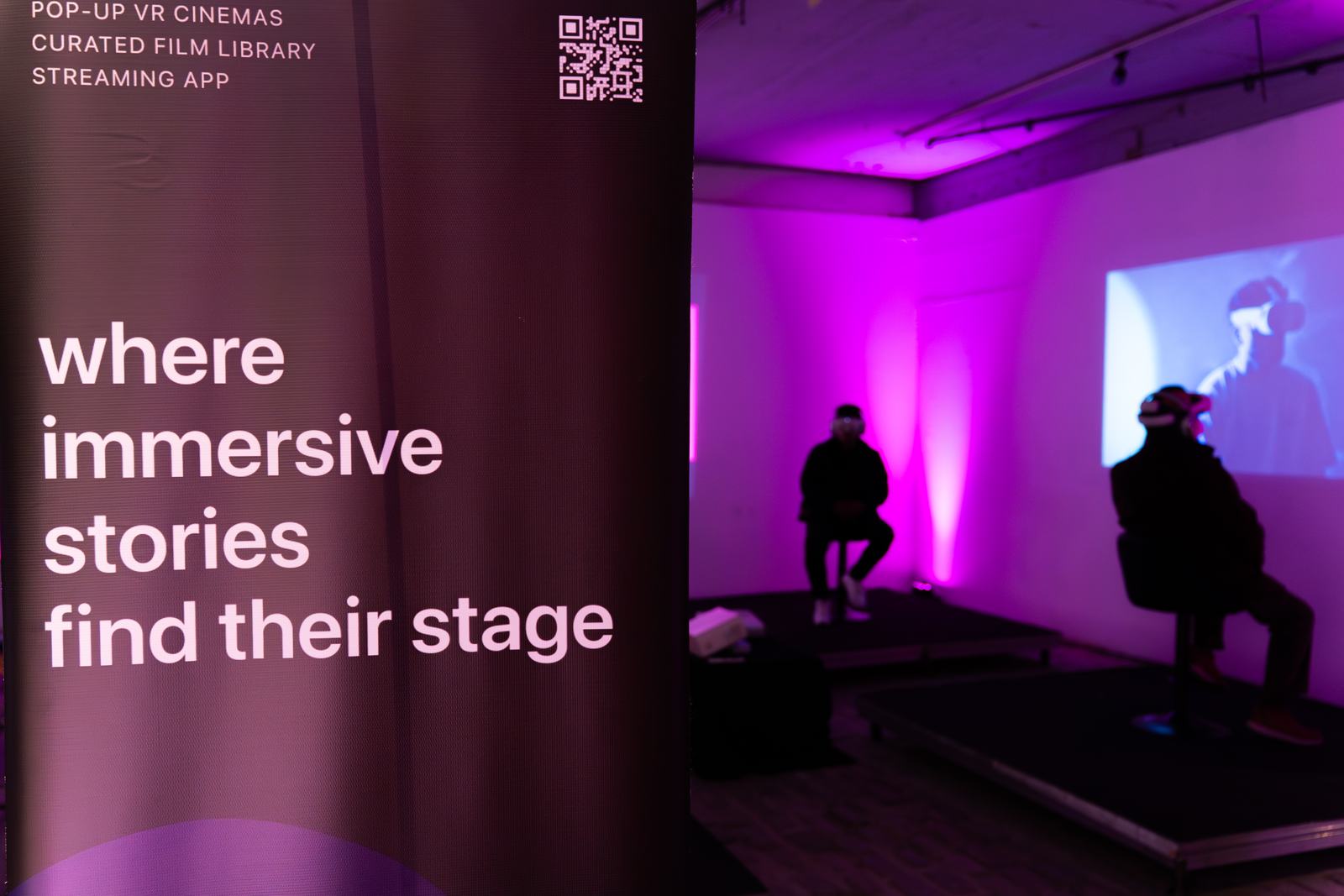 Poetics stage banner beside a purple-lit VR cinema setup