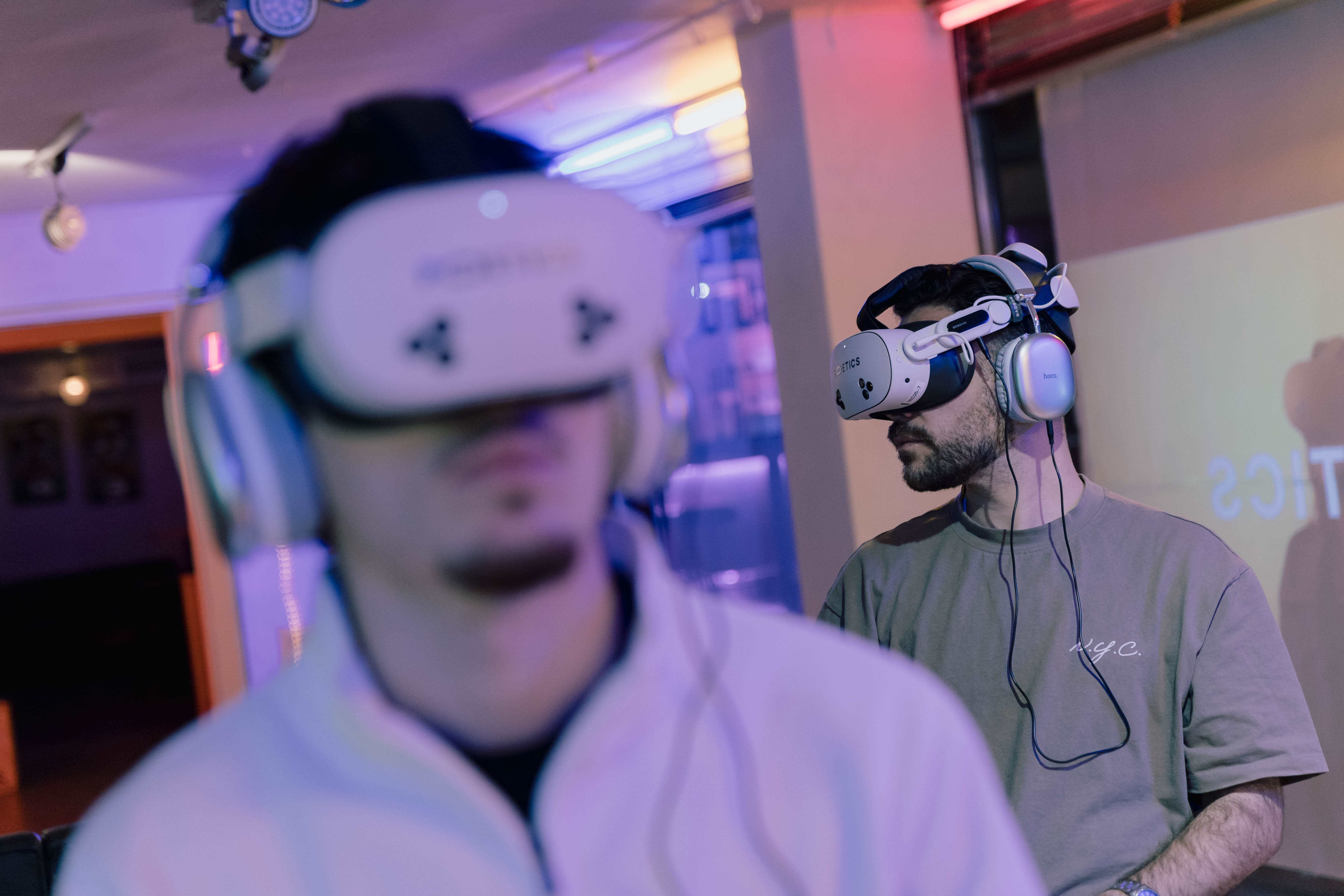 Two visitors wearing Poetics headsets in a cinematic VR setup